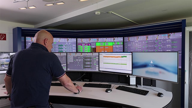 Man looking at wastewater treatment dashboards.