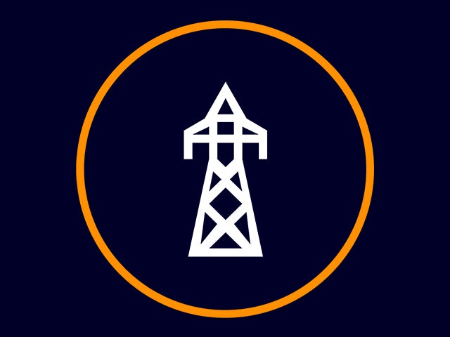 Electric vehicle charging station with solar panels on a roof in an urban setting.