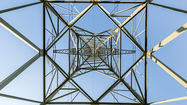 The image shows a transmission line with energy and condition monitoring equipment installed.