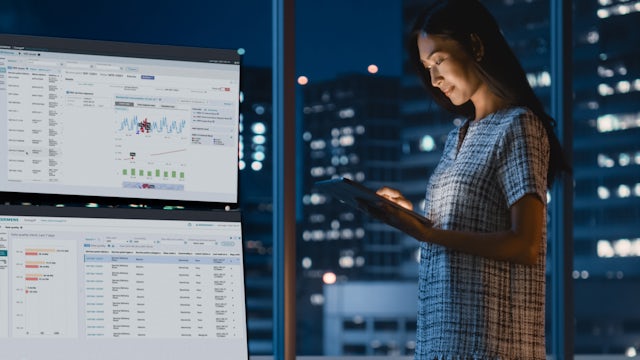 Woman looks at tablet to check EnergyIP MDM X data