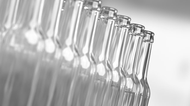 A group of bottles with a label on them are stacked on top of each other.