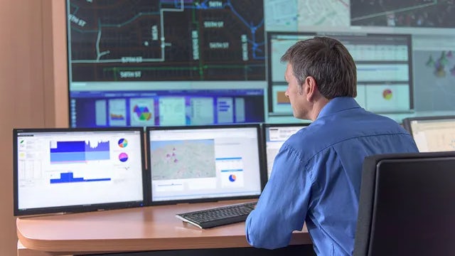 A man is working on a computer in an office.