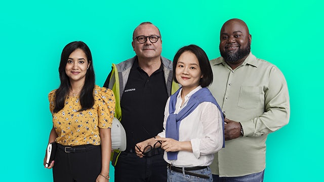 A group of people from diverse ethnic backgrounds standing together in a circle, possibly in a meeting or conference.