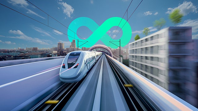 Train on railway tracks with mountains in background