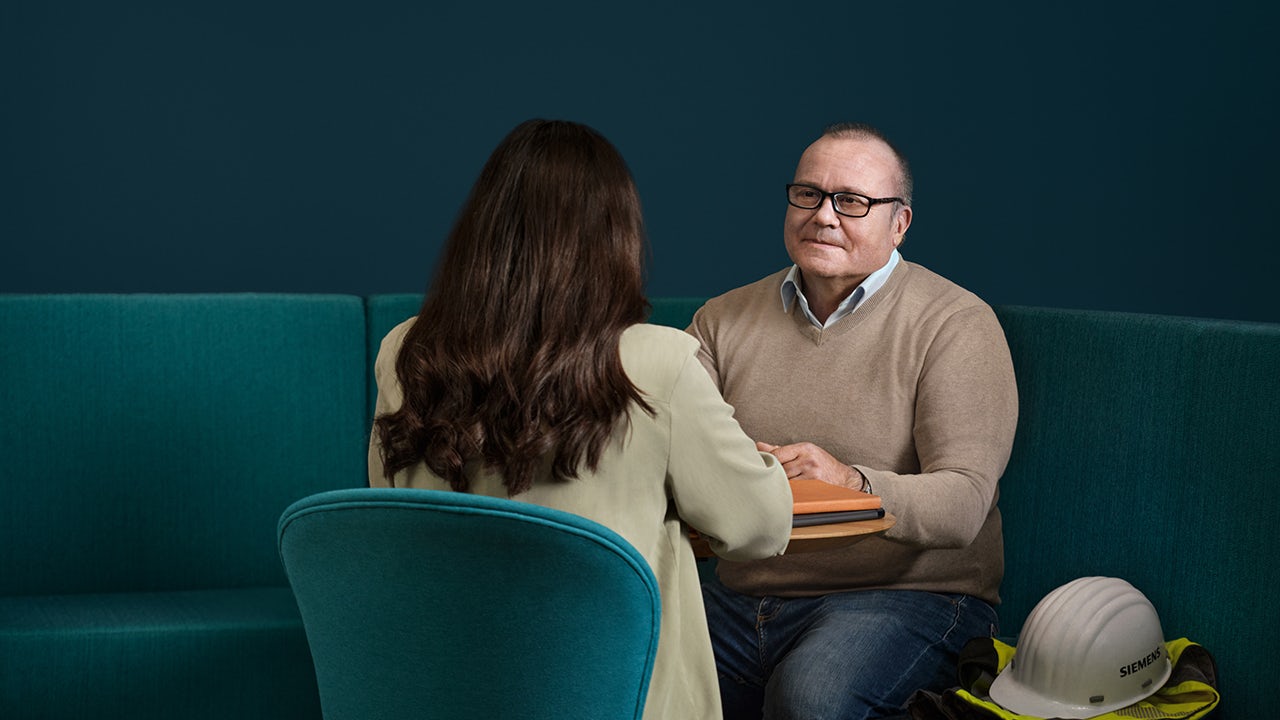 A group of experienced professionals standing together in a conference room.