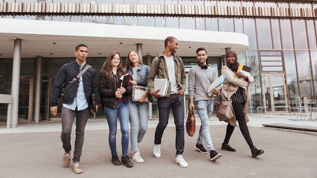 Group of students walking together and smiling.
