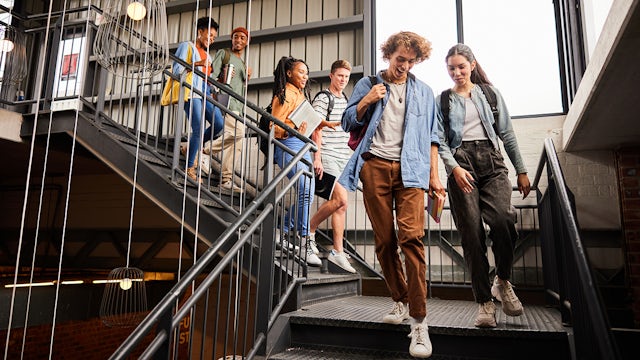 Group of students walking together and smiling.