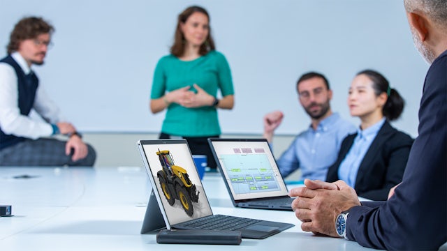 Group of heavy equipment engineers using model-based systems engineering.