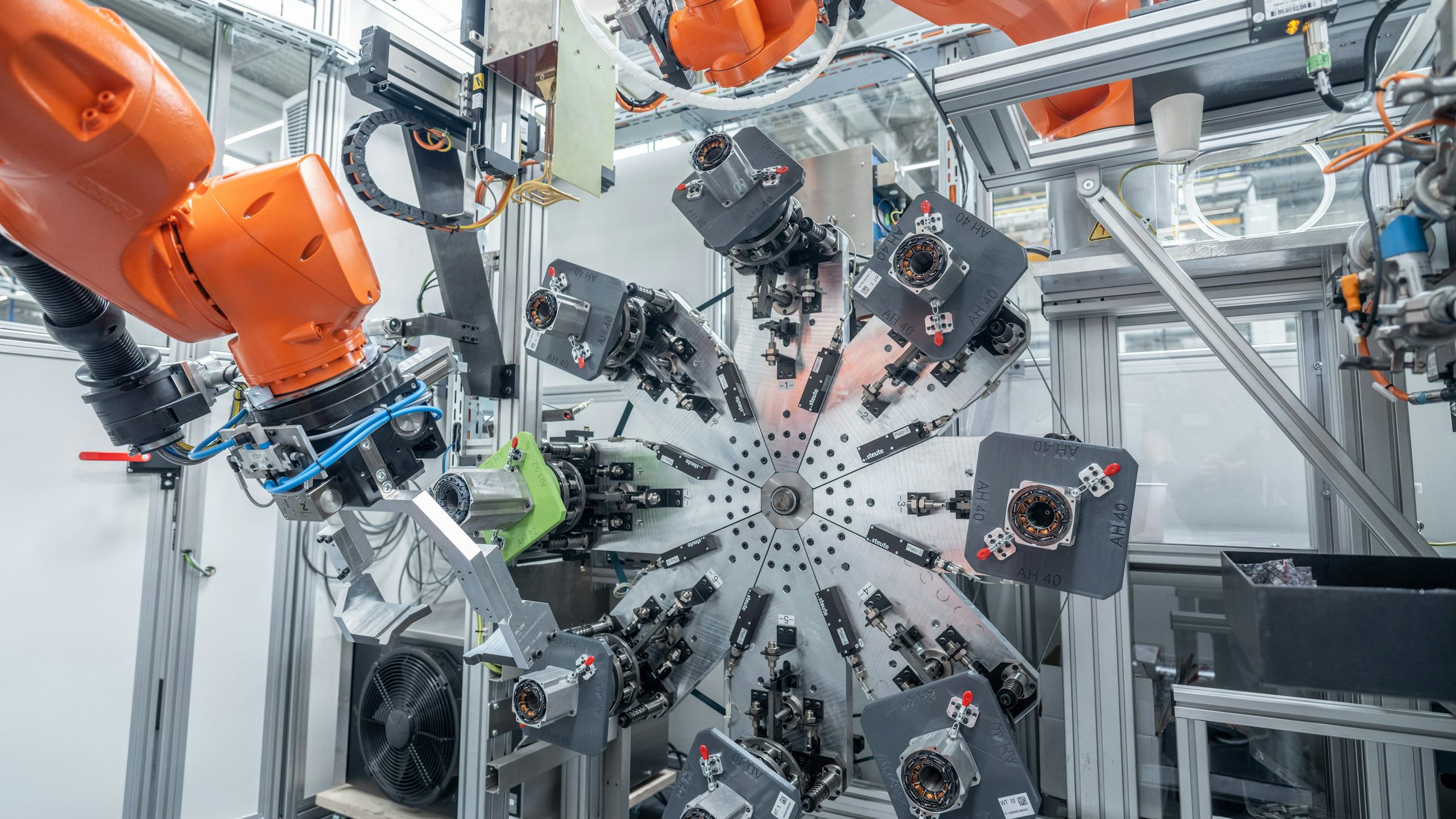 A person is standing in front of a Siemens building with a Siemens logo on the wall.