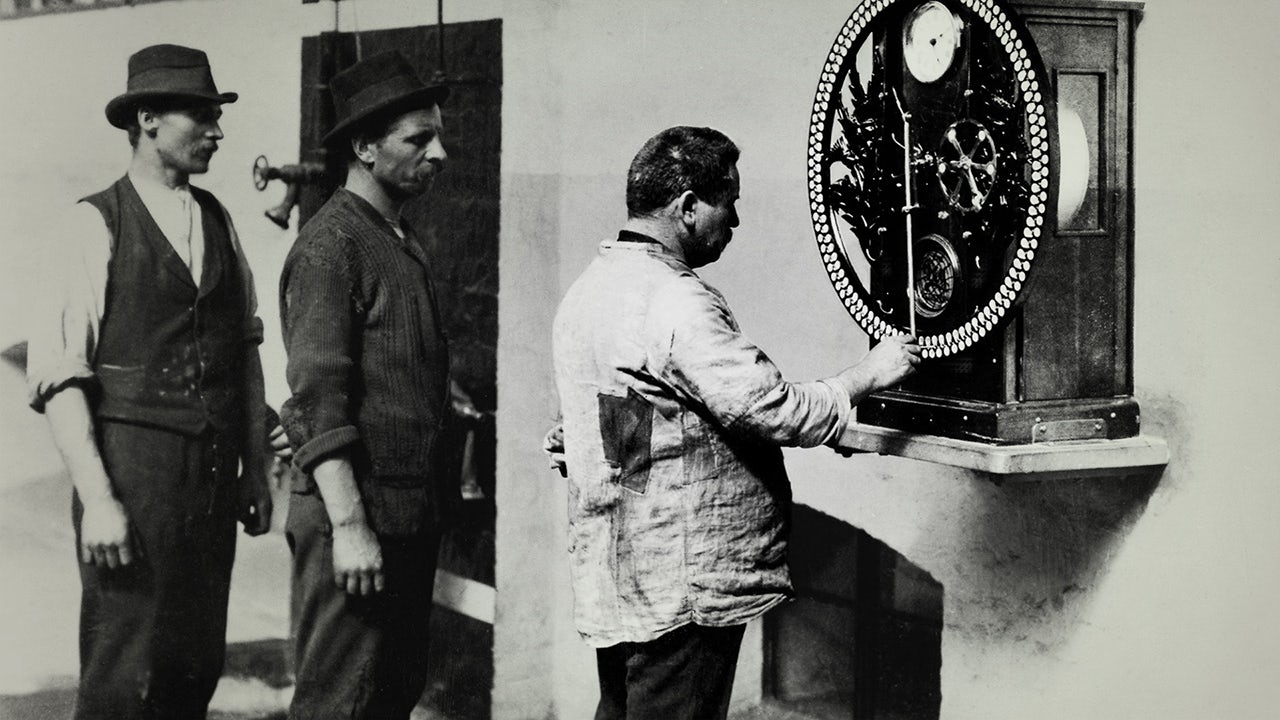 Employees at the control clock, 1900.</br>