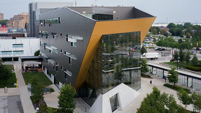 A picture of Humber Polytechnic in Toronto, featuring a modern building with a clear blue sky in the background.