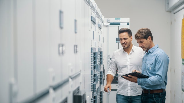 A power distribution board with multiple switches and circuit breakers is mounted on a wall.