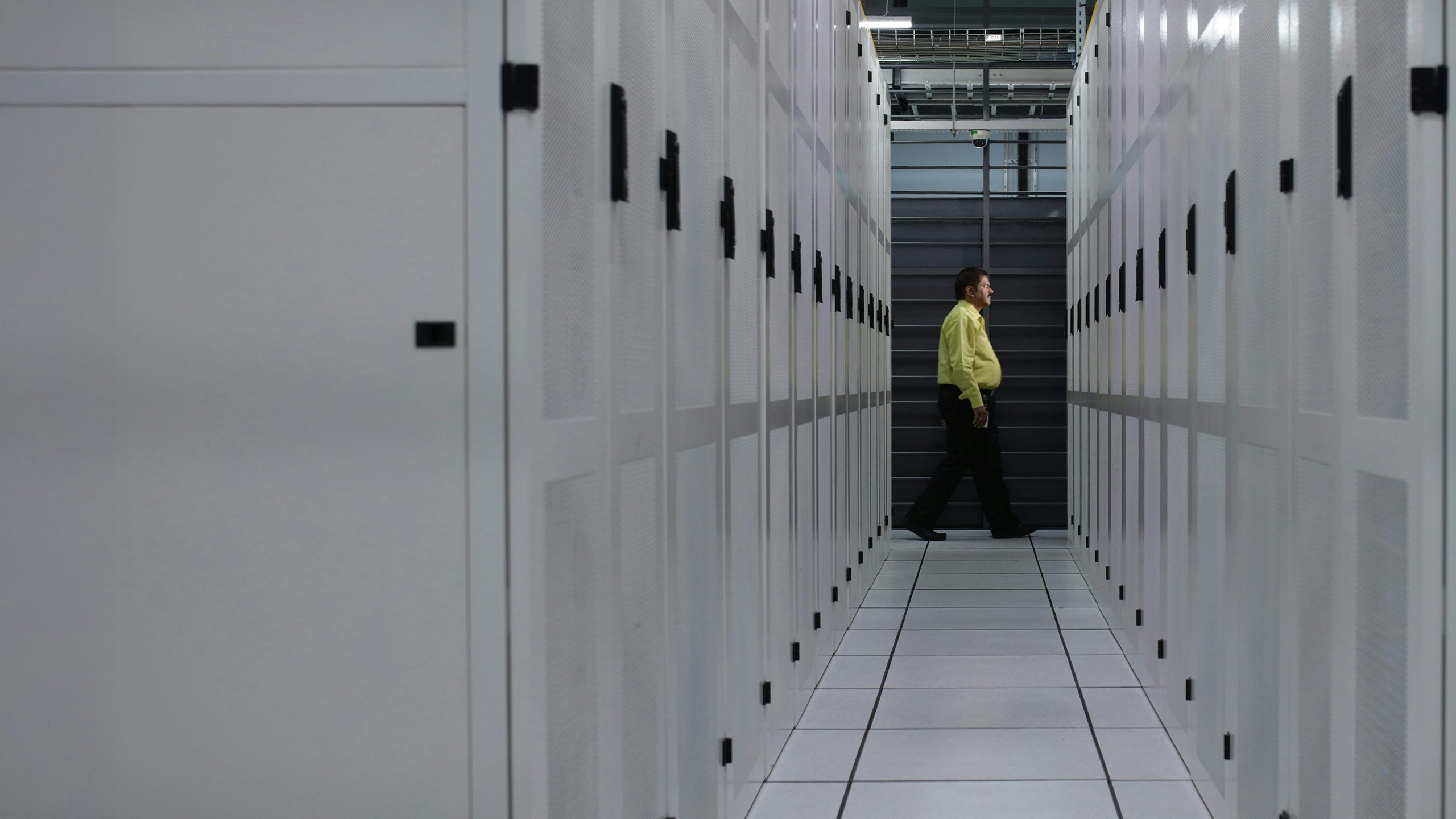 A data center with a modern architectural design, featuring a large glass wall and a modern building in the background.