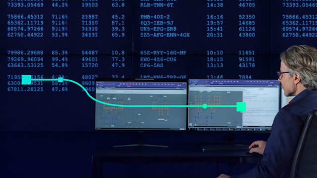 Robotic arm in a factory setting with glowing blue lines representing AI or data connections