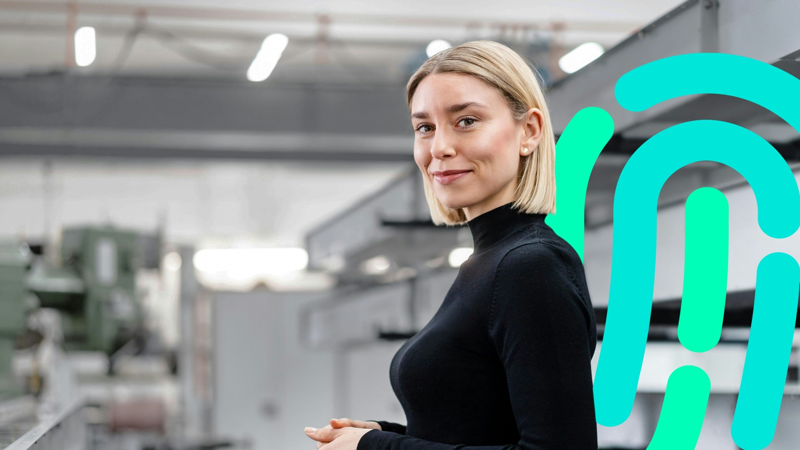 Industrial worker wearing hard hat and safety vest using tablet in front of large machinery with digital overlay