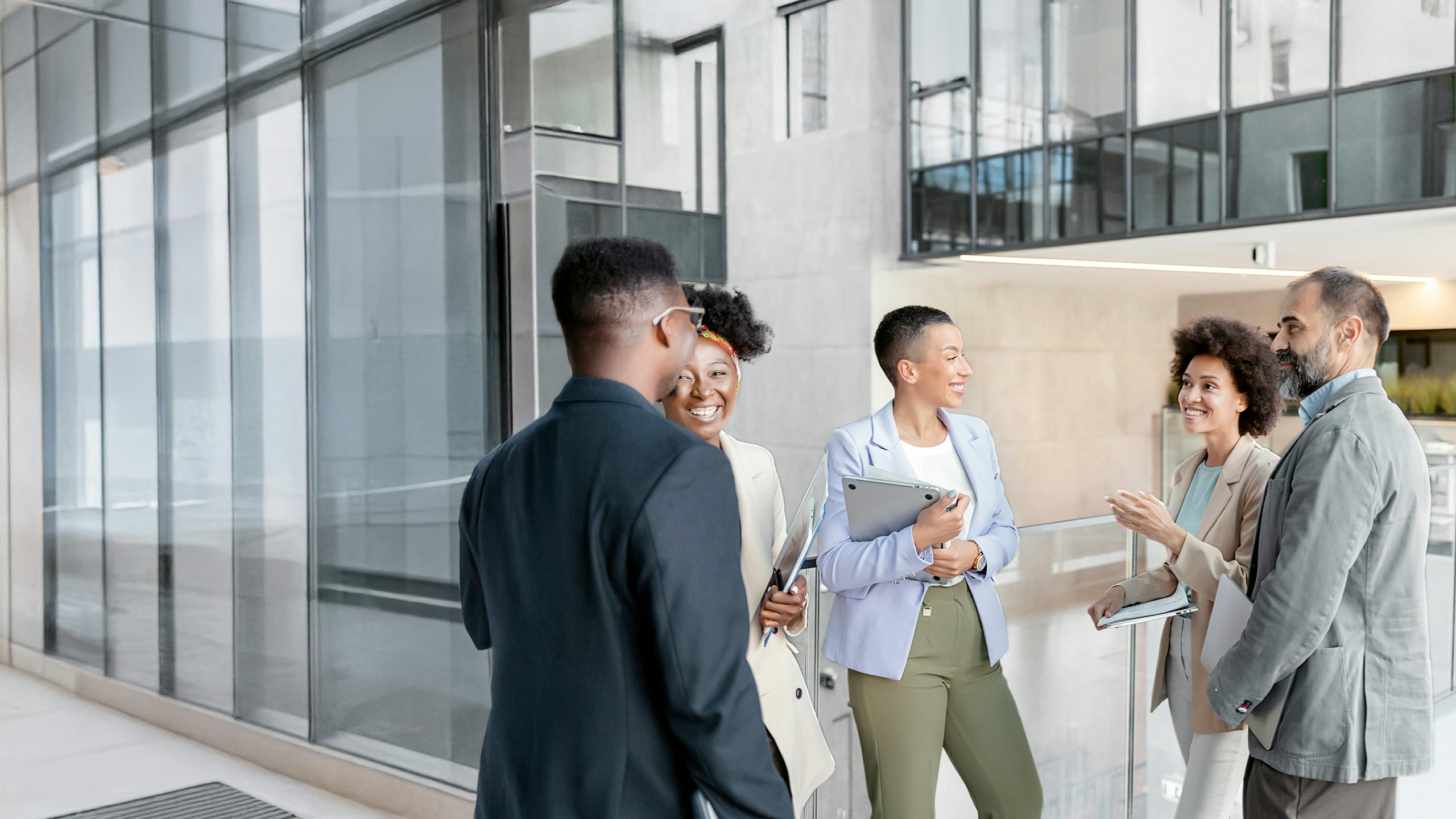 Group of people standing in a circle and talking.