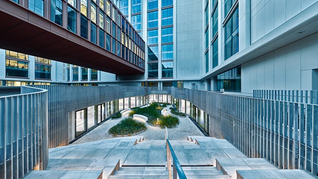 Modern walkway in Siemens and COIMA's renovated smart energy-efficient building in Milan's Porta Nuova district.