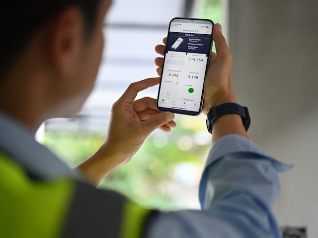 A Siemens Intelli-Arc welding robot with a torch attached to its arm, positioned in a factory setting.
