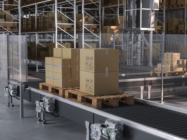 A conveyor belt system in an industrial setting with a person operating the machinery.