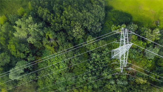 A poster with a blue background and a white energy symbol in the center, surrounded by a circle of smaller icons.