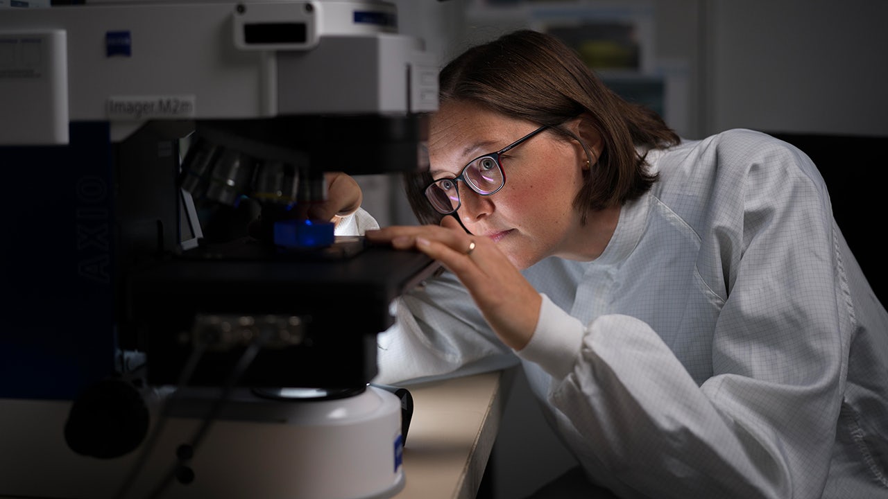 The image shows a person in a thoughtful pose, possibly contemplating the future of circular electronics.