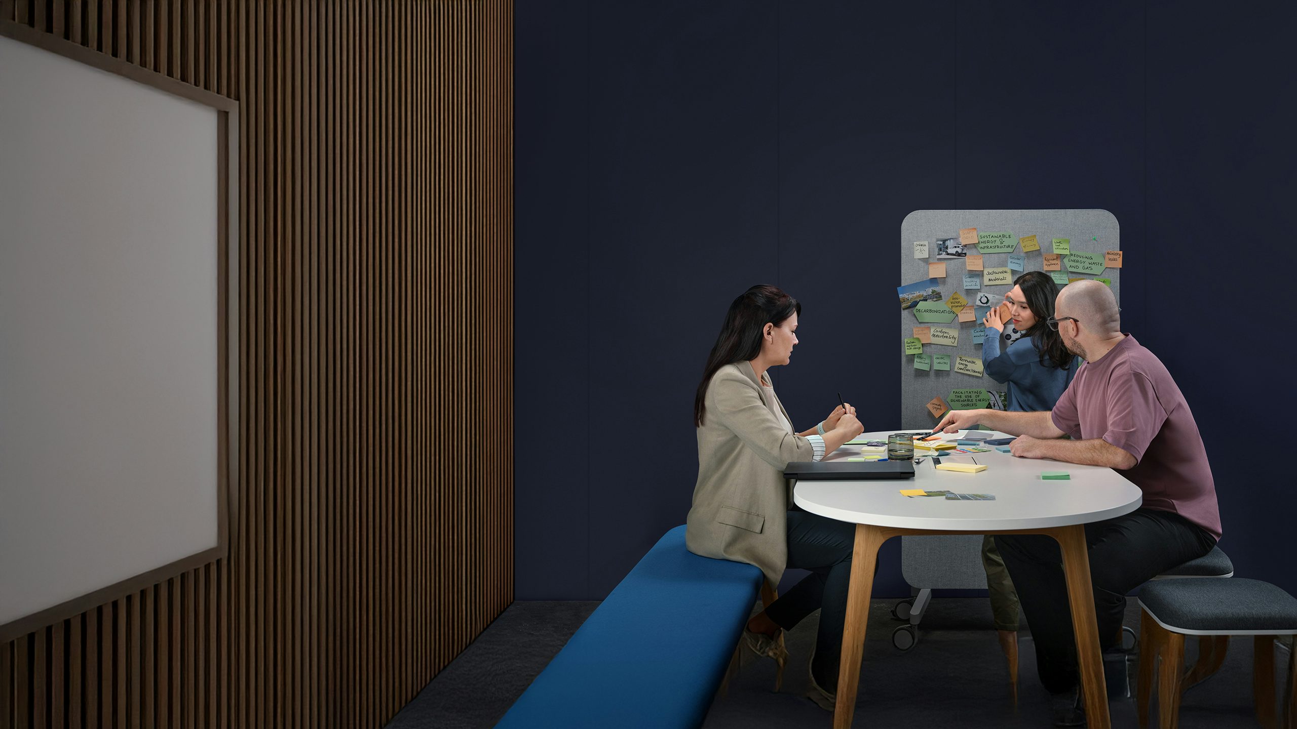 A person is standing in front of a desk with a laptop and a cup of coffee.