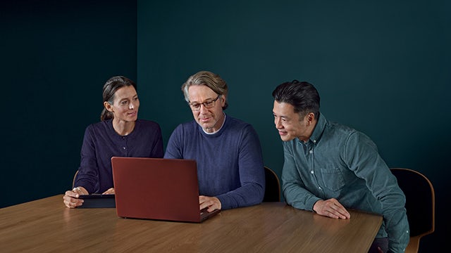 A person is standing in front of a computer screen, possibly working on a project.