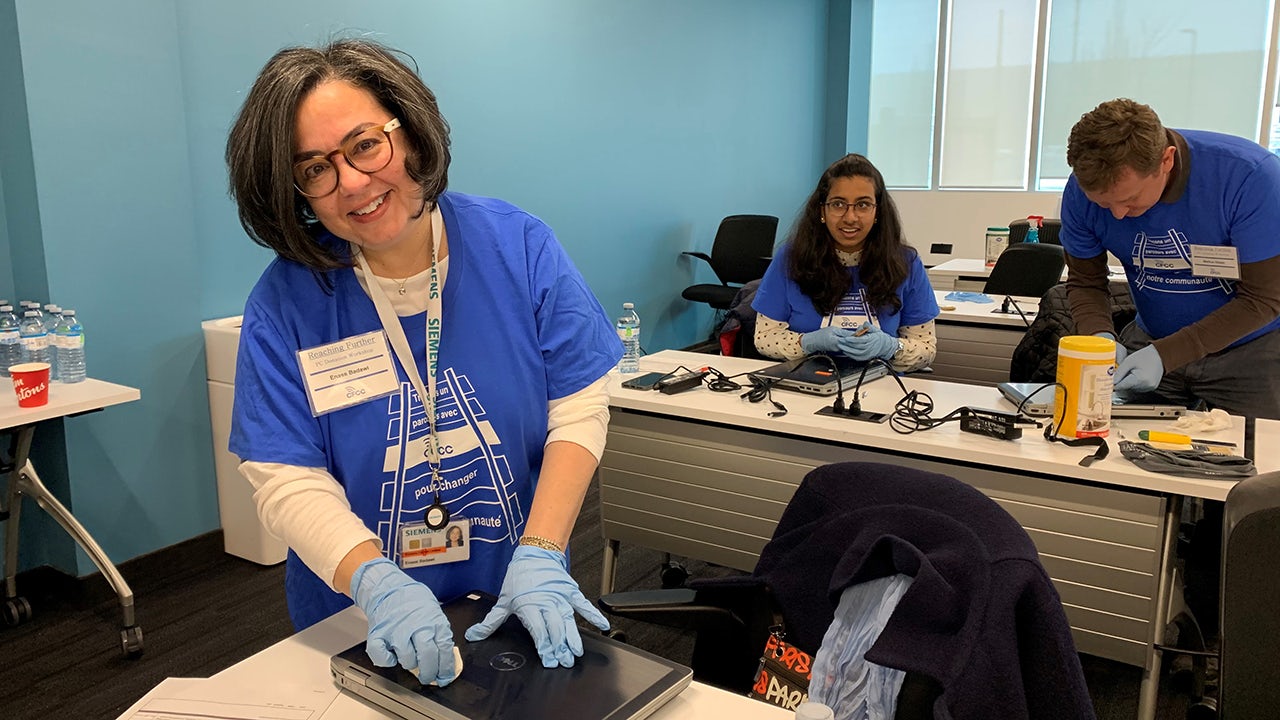 Laptop donations being collected for a charity event.