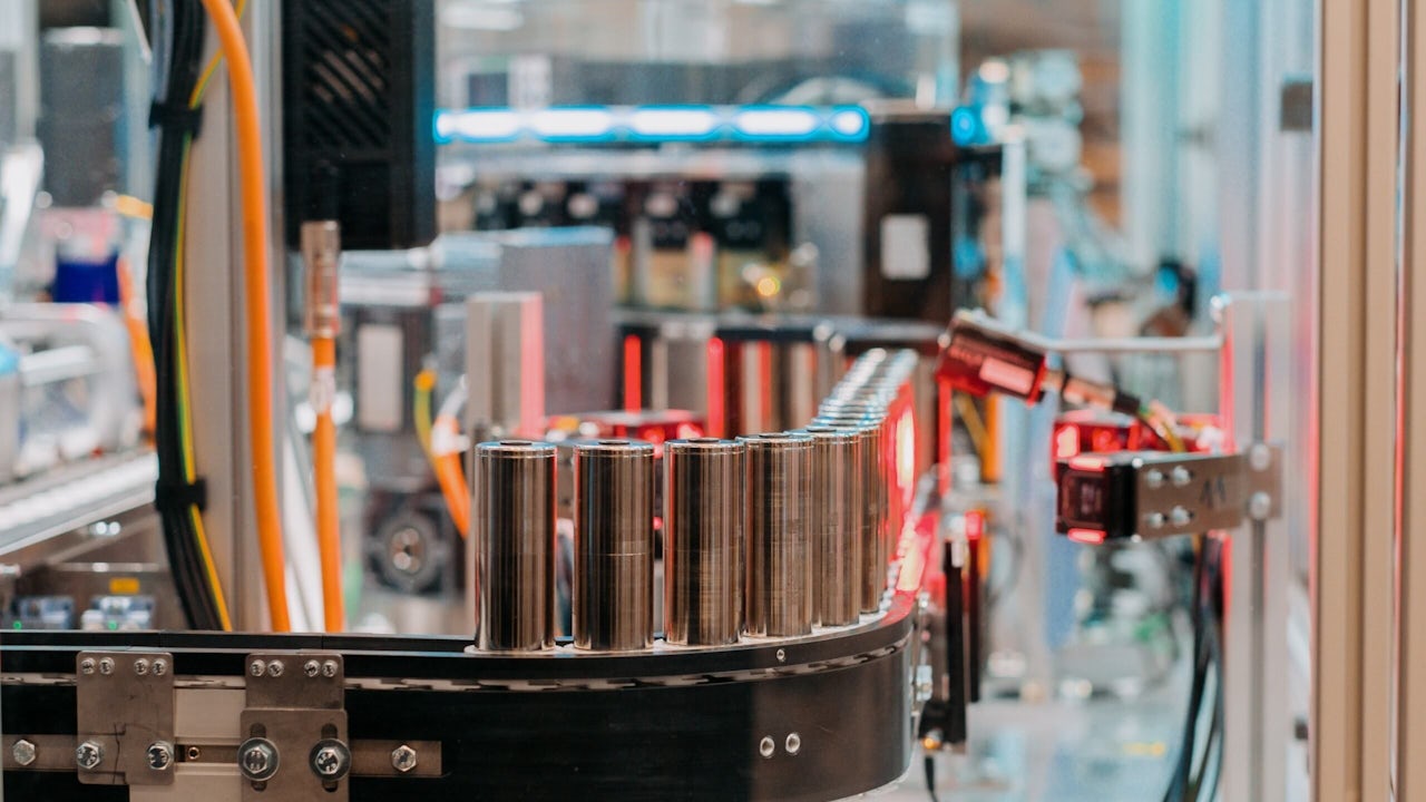 A machine is testing battery cells in a laboratory setting.