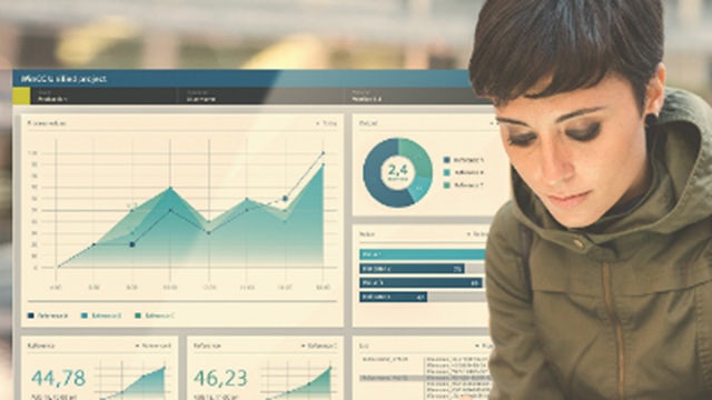 Person uses a tablet with performance dashboard in background