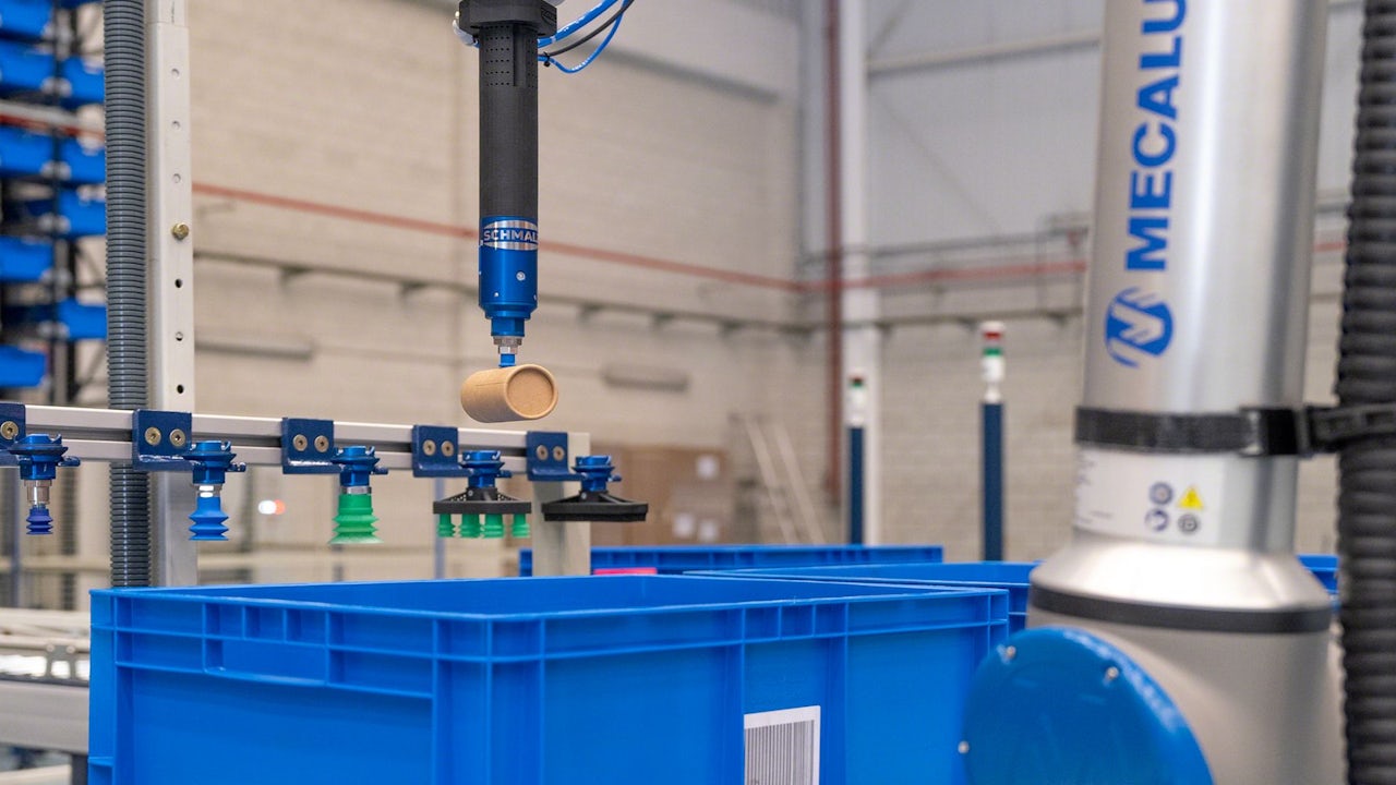 The image shows a warehouse with a robot picking up a box from a pallet.