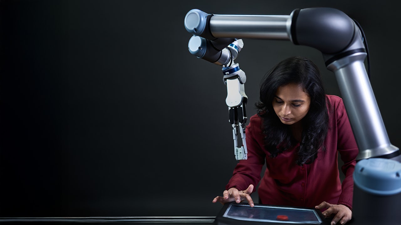 A person is standing in front of a whiteboard with a diagram and text written on it.