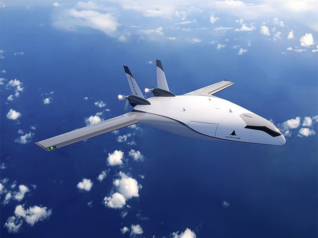 Cargo aircraft flying over ocean with container ship below