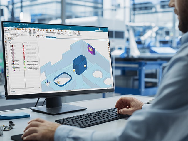 A person is standing in front of a white wall with a blue and white sign on it.