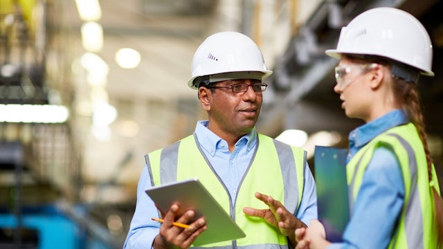 Two people discussing operations in a facility.
