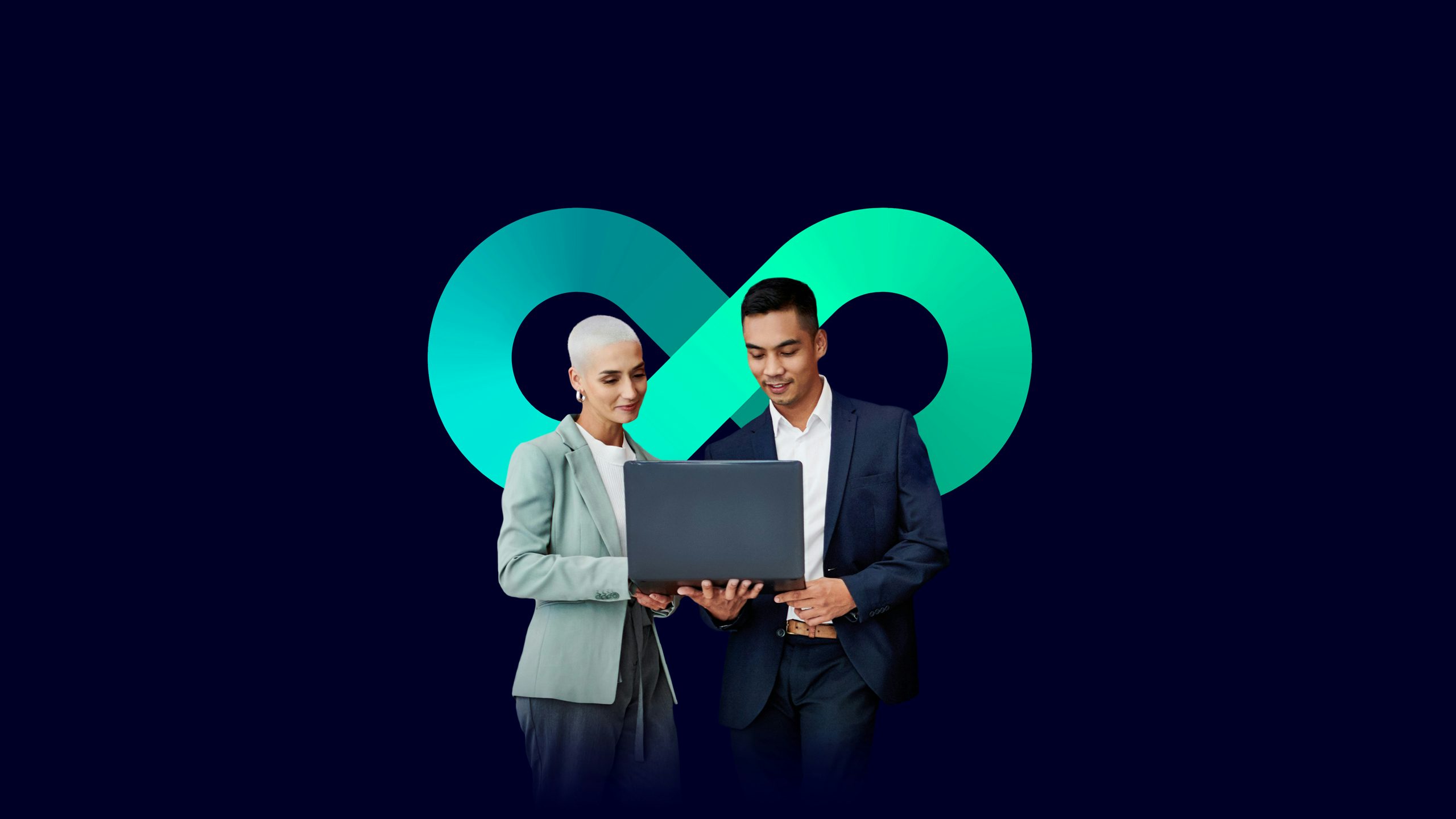2 people standing with a laptop in front of the infinity loop.
