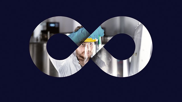 Man working in mask on pharmaceutical experiments.