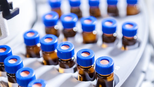Close-up of vials in a pharmaceutical vial inspection machine.