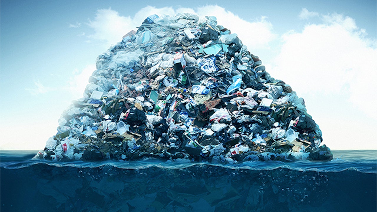 A pile of garbage with plastic bottles, cans, and other waste materials.