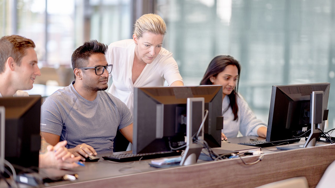 A group of professionals in a meeting discussing power system consulting and planning.