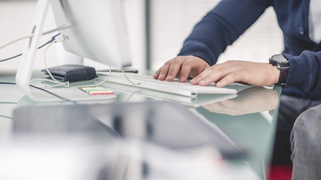 Person typing on a keyboard.
