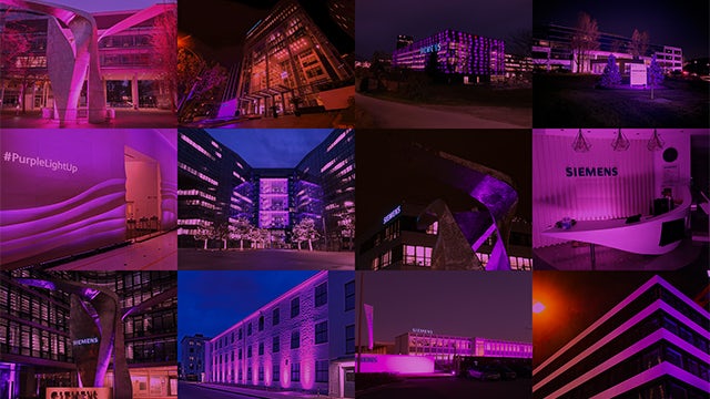 A purple flower with a blurry background and a watermark in the bottom right corner.