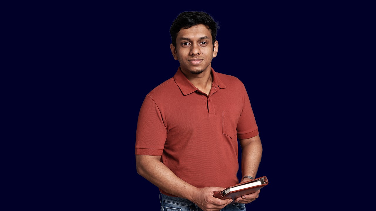A poster with a child holding a book and a teacher beside him, promoting quality education in India.