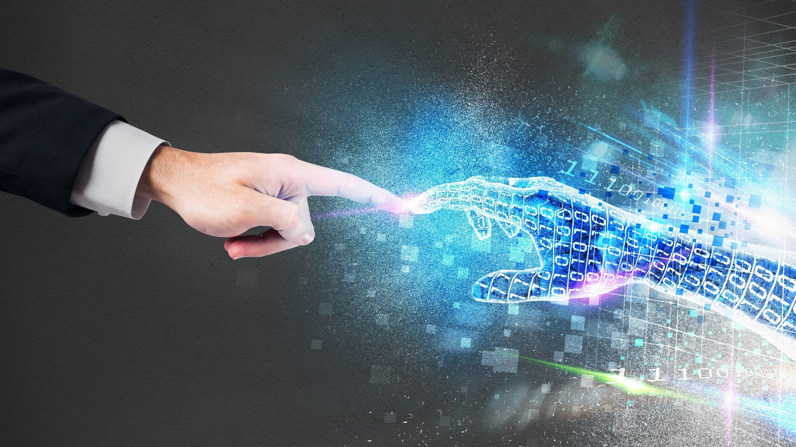 two hands come together from the real and the digital world