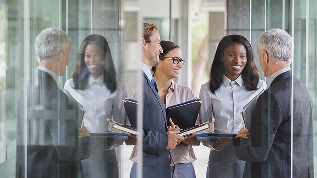 Group of business people standing and smiling.