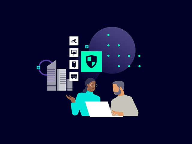 Two professionals view security benefits on a computer monitor.