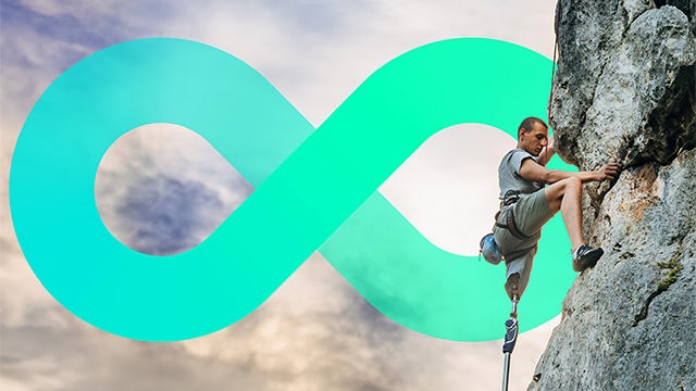 Man with prosthetic leg climbing a rock face.