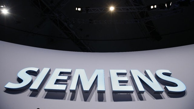 Photo of a 3d Siemens sign from below.