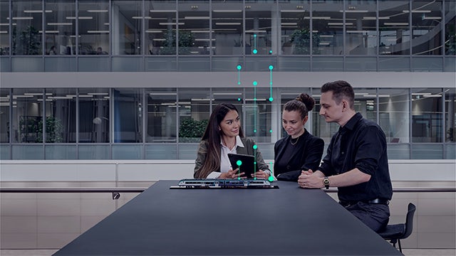 Three colleagues working on a tablet