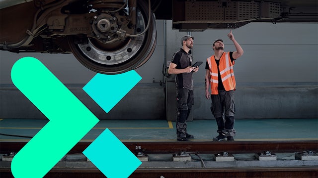 Workers inspecting train undercarriage, teal logo in foreground.